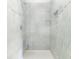 Large shower with marble-style tile and built-in shelf at 105 Equestrian Ct, Summerville, SC 29486