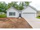 Newly constructed home with white siding, two-car garage, and a spacious yard at 105 Equestrian Ct, Summerville, SC 29486