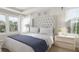 Main bedroom with tufted headboard, ample natural light, and ensuite bath at 208 Greenling St, Goose Creek, SC 29445
