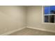 Simple bedroom with neutral walls, carpet, and a window at 208 Greenling St, Goose Creek, SC 29445