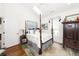 Bright bedroom featuring a four-poster bed and hardwood floors at 2128 Rookery Ln, Charleston, SC 29414