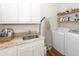 Bright laundry room with washer, dryer, and granite countertop at 2128 Rookery Ln, Charleston, SC 29414