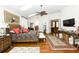 Large main bedroom with hardwood floors, a ceiling fan, and access to the bathroom at 2128 Rookery Ln, Charleston, SC 29414