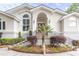 House exterior with stucco walls, arched entryway, and landscaping at 2128 Rookery Ln, Charleston, SC 29414