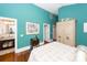 Serene bedroom with teal walls, hardwood floors, and a large armoire at 2128 Rookery Ln, Charleston, SC 29414