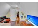 Cozy attic office features hardwood floors, built-in shelving and a view into the hallway at 197 Coming St, Charleston, SC 29403