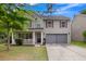 Two-story house with a gray exterior, double garage, and front porch at 215 Breckingridge Dr, Ladson, SC 29456