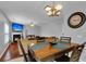 Dining room with wooden table and chairs, view of living room and fireplace at 215 Breckingridge Dr, Ladson, SC 29456