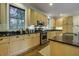 Kitchen with light wood cabinets, granite counters, and stainless steel appliances at 614 E Cooper Ave, Folly Beach, SC 29439