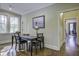 Bright game room with table, chairs and access to other rooms at 614 E Cooper Ave, Folly Beach, SC 29439