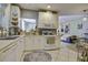 Spacious kitchen, white cabinets, view into living area at 614 E Cooper Ave, Folly Beach, SC 29439