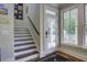 Elegant staircase leading to the upper level with a view to a porch at 614 E Cooper Ave, Folly Beach, SC 29439