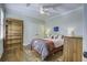 Bright bedroom with hardwood floors, built-in shelves, and a comfortable bed at 614 E Cooper Ave, Folly Beach, SC 29439