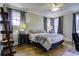 Spacious bedroom with a comfortable bed, hardwood floors, and ample natural light at 614 E Cooper Ave, Folly Beach, SC 29439