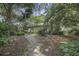 Secluded guest house with stone pathway and tropical landscaping at 614 E Cooper Ave, Folly Beach, SC 29439