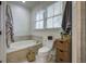 Relaxing bathroom with a bathtub, toilet, and plenty of storage at 614 E Cooper Ave, Folly Beach, SC 29439