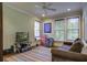 Relaxing media room featuring comfortable seating, a large TV, and built-in shelving at 614 E Cooper Ave, Folly Beach, SC 29439