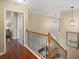 Upstairs hallway with hardwood floors and wrought iron railing at 3336 Toomer Kiln Cir, Mount Pleasant, SC 29466