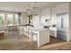 Modern white kitchen with a large island and stainless steel appliances at 540 Helmsman St # 1232, Daniel Island, SC 29492