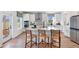 Open concept kitchen boasts island, white cabinets, and stainless steel appliances at 127 Winding Grove Ln, Moncks Corner, SC 29461