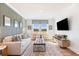 Bright game room features a comfortable sofa and built-in entertainment center at 127 Winding Grove Ln, Moncks Corner, SC 29461