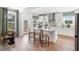 White kitchen features island with seating, stainless steel appliances, and access to backyard at 127 Winding Grove Ln, Moncks Corner, SC 29461
