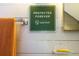 Close-up of a green sign on a white wood wall at 8871 Palmetto Rd # 33 Ac Private Island, Edisto Beach, SC 29438
