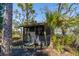 Charming screened-in bunkhouse or relaxing area with palm trees nearby at 8871 Palmetto Rd # 33 Ac Private Island, Edisto Beach, SC 29438