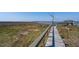Wooden walkway leading to gazebo over calm water at 8871 Palmetto Rd # 33 Ac Private Island, Edisto Beach, SC 29438