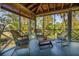 Spacious screened porch with wicker furniture and seating area at 8871 Palmetto Rd # 33 Ac Private Island, Edisto Beach, SC 29438