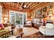 Living room with custom doors and windows, comfy seating, and wood features at 8871 Palmetto Rd # 33 Ac Private Island, Edisto Beach, SC 29438