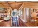 Rustic farmhouse dining area with wood walls, long table, and colorful chairs at 8871 Palmetto Rd # 33 Ac Private Island, Edisto Beach, SC 29438