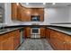 Modern kitchen with stainless steel appliances and dark cabinets at 5565 Colonial Chatsworth Cir, North Charleston, SC 29418