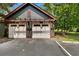 Two-car garage with white doors and pergola at 5565 Colonial Chatsworth Cir, North Charleston, SC 29418
