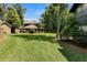 Large grassy backyard with trees and houses at 5565 Colonial Chatsworth Cir, North Charleston, SC 29418