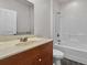 Clean bathroom with wood vanity, tub, and toilet at 5565 Colonial Chatsworth Cir, North Charleston, SC 29418