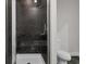 Modern shower with dark tile and glass enclosure at 5565 Colonial Chatsworth Cir, North Charleston, SC 29418