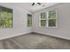 Bright bedroom with grey carpet and multiple windows at 5565 Colonial Chatsworth Cir, North Charleston, SC 29418