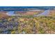 Aerial view of a community by the river, featuring houses and lush greenery at 5565 Colonial Chatsworth Cir, North Charleston, SC 29418