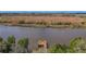 Aerial view of a waterfront property with a wooden deck at 5565 Colonial Chatsworth Cir, North Charleston, SC 29418
