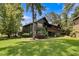 Two-story house with screened porch and landscaping at 5565 Colonial Chatsworth Cir, North Charleston, SC 29418
