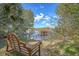 Wooden bench overlooking a peaceful river and dock at 5565 Colonial Chatsworth Cir, North Charleston, SC 29418
