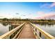 Long wooden dock extending over calm river waters at 5565 Colonial Chatsworth Cir, North Charleston, SC 29418