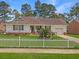 Charming ranch home with white picket fence, manicured lawn, and attached garage at 917 Aleppo Dr, Ladson, SC 29456