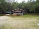 Quaint waterfront cabin with screened porch, nestled in a wooded setting at 31 Hannibal Dr, Ridgeville, SC 29472