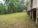Large backyard with mature trees and a wooden fence at 31 Hannibal Dr, Ridgeville, SC 29472