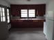 Small kitchen with dark wood cabinets and a white refrigerator at 31 Hannibal Dr, Ridgeville, SC 29472