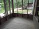 Empty screened porch with wood flooring and views of the backyard at 31 Hannibal Dr, Ridgeville, SC 29472