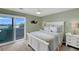 Charming bedroom features a white bed frame and access to a private balcony at 18 W Mariners Cay Dr, Folly Beach, SC 29439