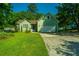 Green house with a two-car garage and well-manicured lawn at 520 Woodland Shores Rd, Charleston, SC 29412